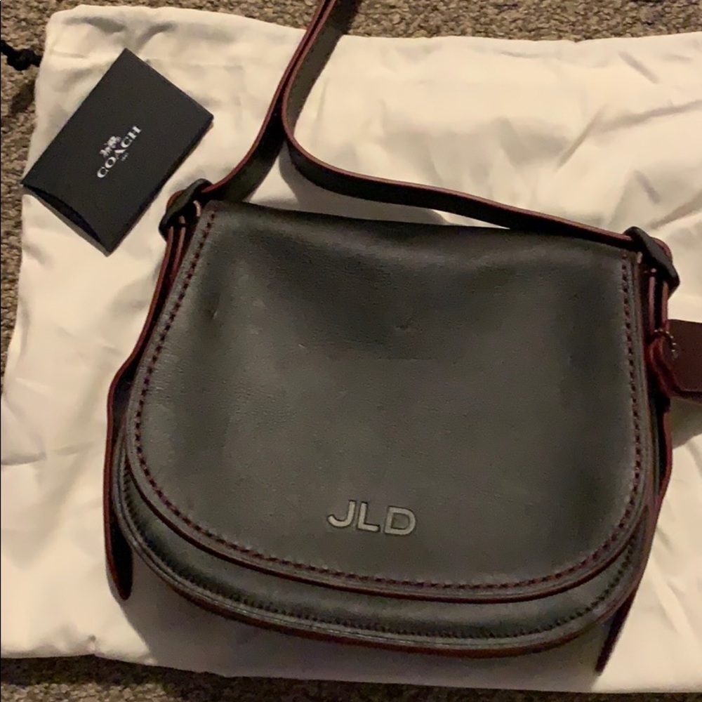 Coach Saddle Bag purse never used. Black and red.